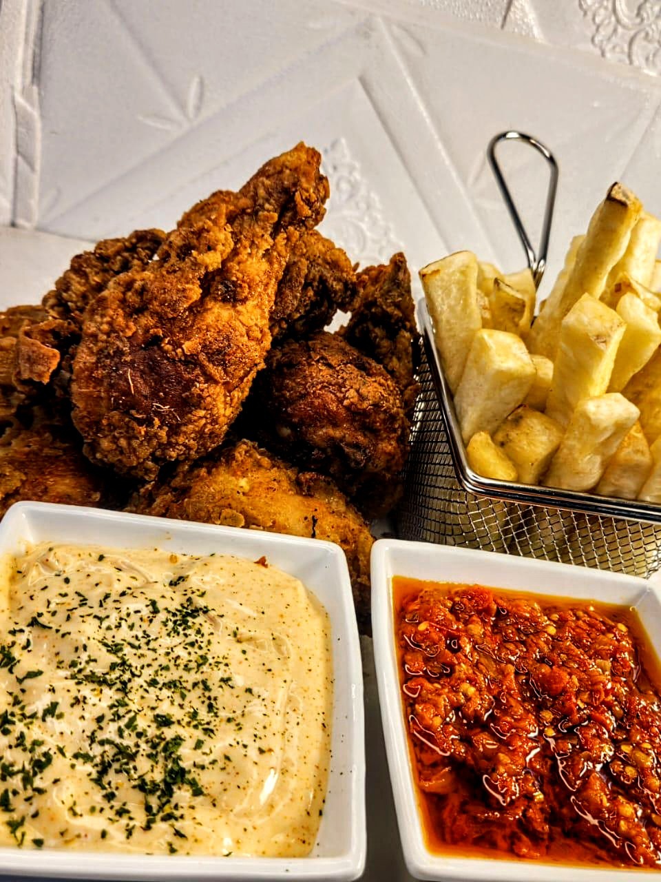 Fried chicken tenders and fries with dipping sauces.