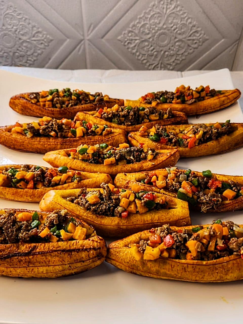 Plantain canoes filled with meat and vegetables.